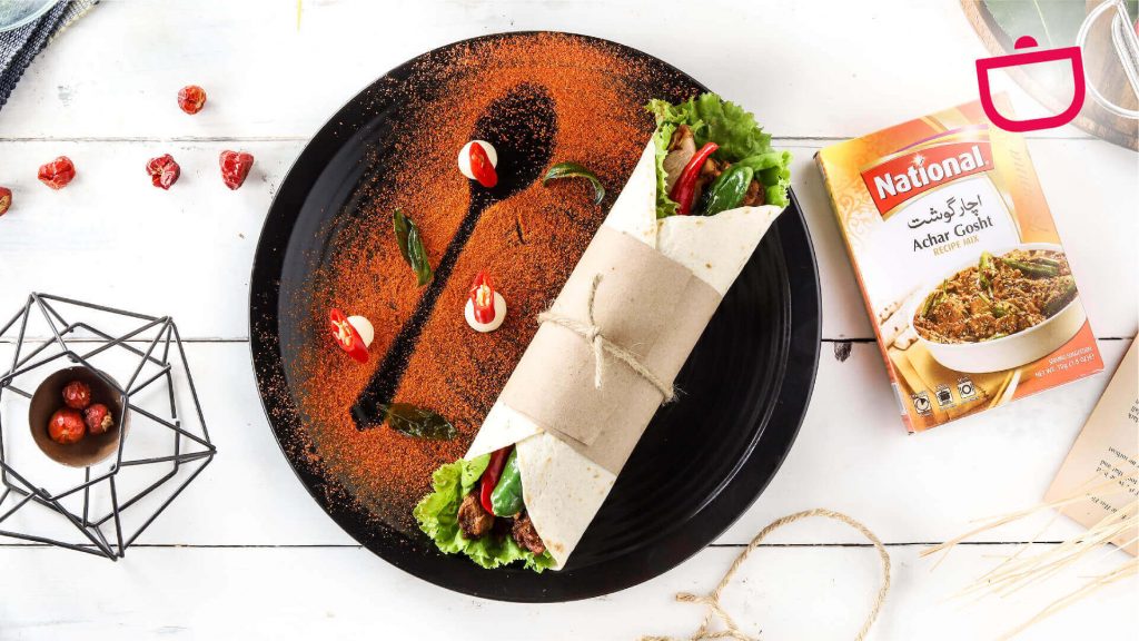 Achari Wraps on black plate with National Achar Gosht Masala